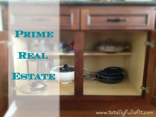Prime Real Estate playing in cupboards playing in the kitchen