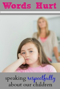Little girl looking annoyed sitting at kitchen table with mother in background
