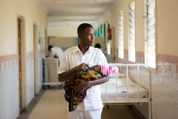 Nurse Midwife Daniel Paulo at work in his ward for women who had caesarians or who have been admitted with complications pre and post partum. Kiomboi District Hospital, Kiomboi, Tanzania.
