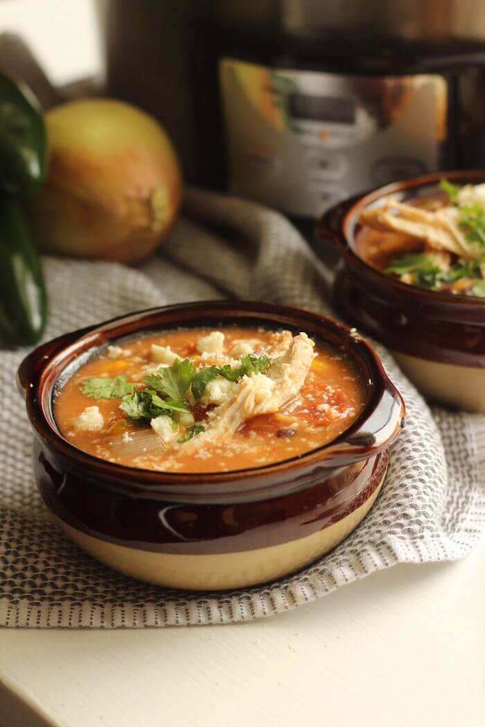 This quick and easy hearty crockpot soup is a family pleaser! Our chicken enchilada soup is great for families, potlucks and a perfect soup to share.
